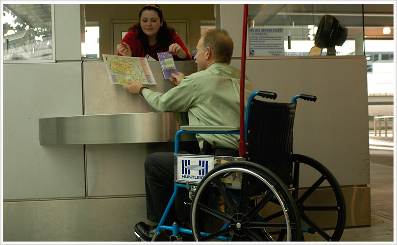 man looking at maps at info booth