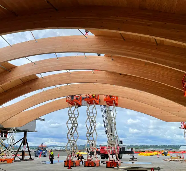 three scissor lifts working in roof beams