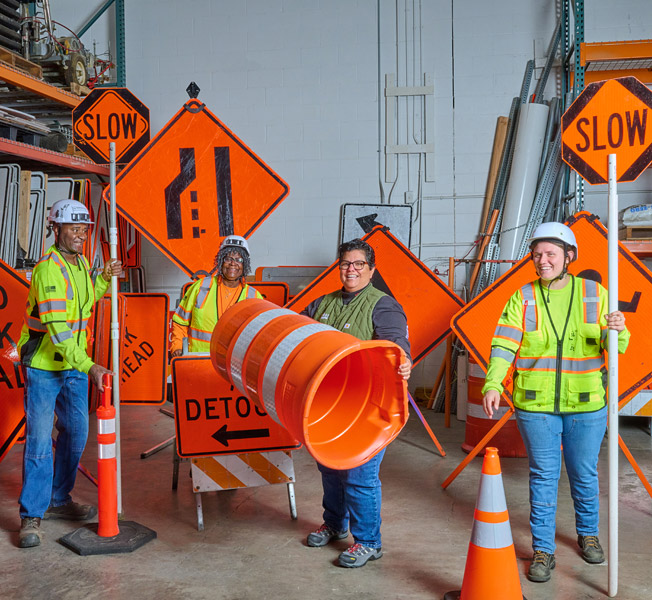 laughing employees in reflective gear