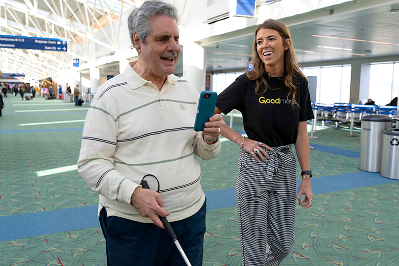 PDX Accessibility Committee member Pete DeVasto works with a GoodMaps representative to test the app