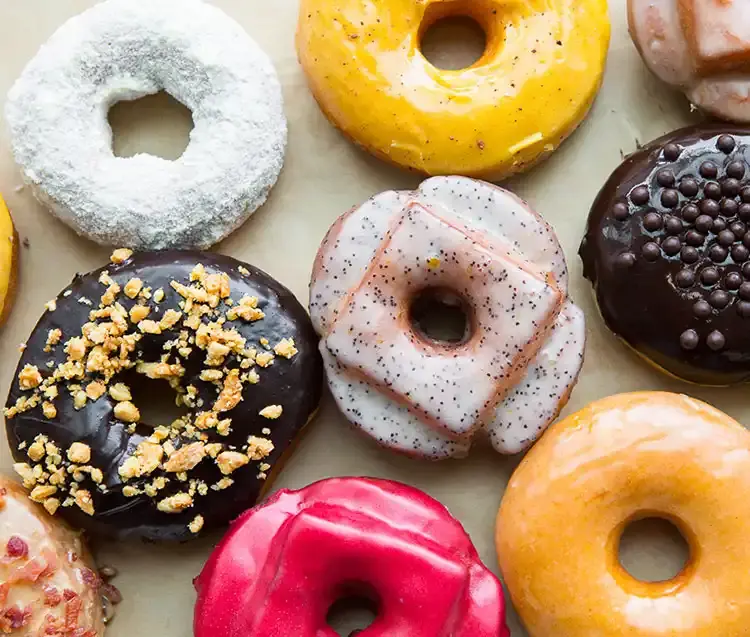 eight donuts in a variety of colorful flavors