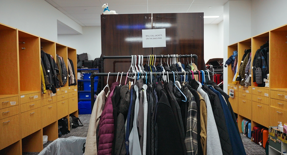 inside lost and found shows multiple racks of jackets and a sign that says will call jackets on back rail