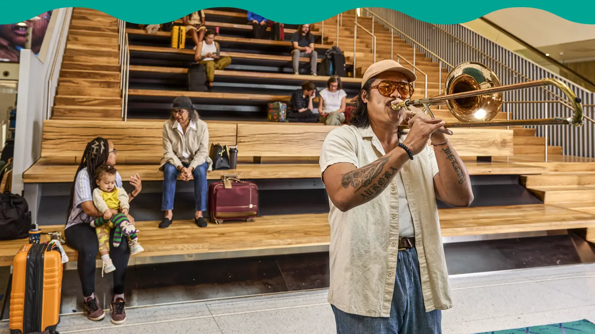 Man playing trumpet in front of stadium setting at PDX