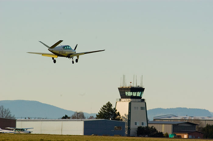 Hillsboro Airport plane in foreground with air traffic control in background