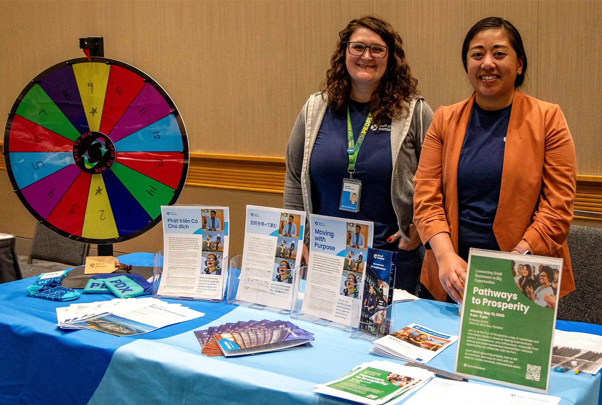 two women tabling at the Port of Portland table with a prize wheel and various printed handouts