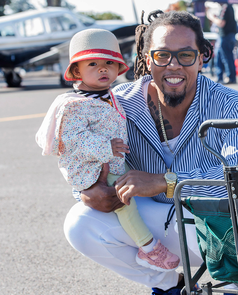 Black man holding his small child