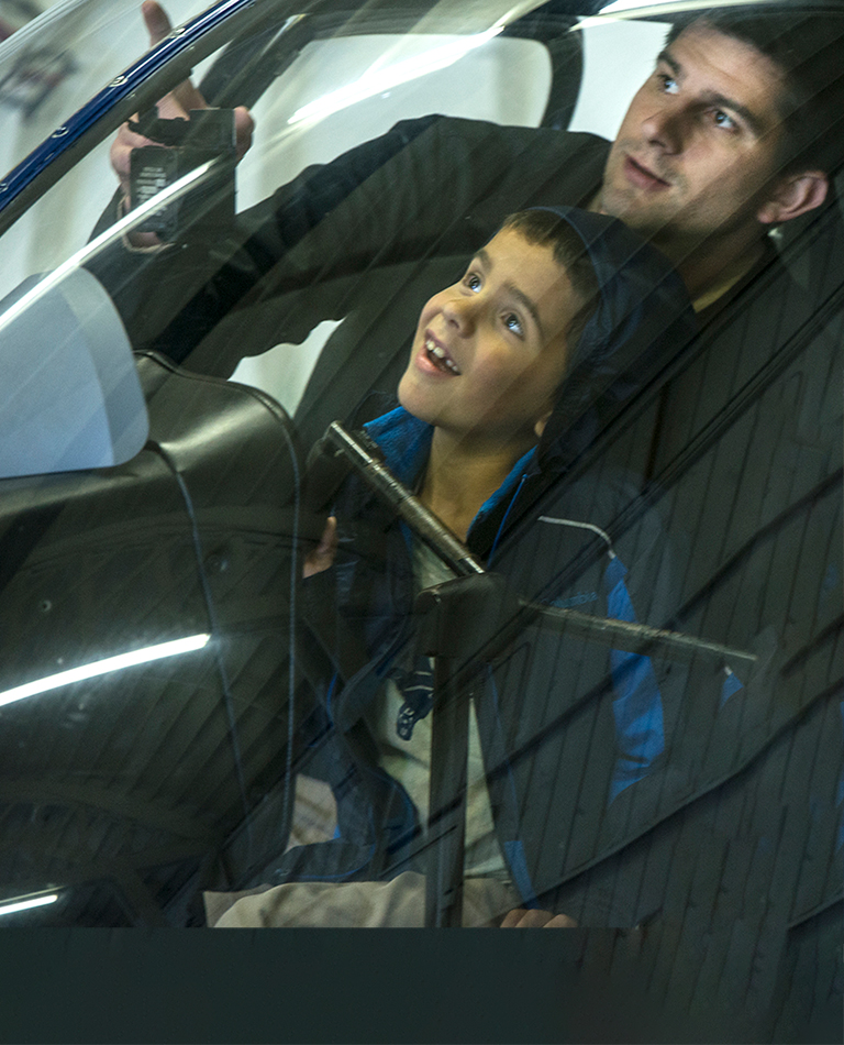 Man with two young children inside helicopter