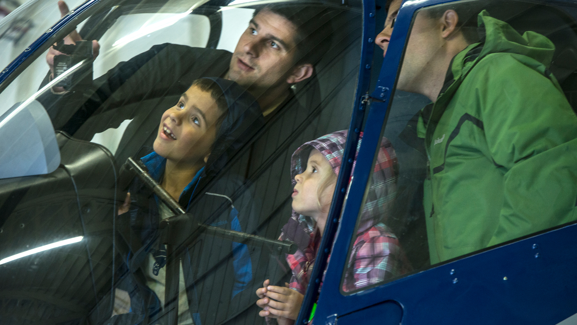 Two men with young children inside helicopter