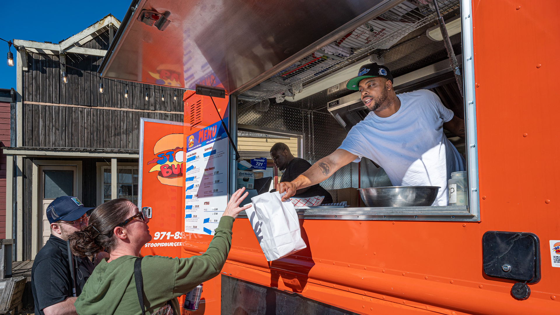Men handing out food from food truck
