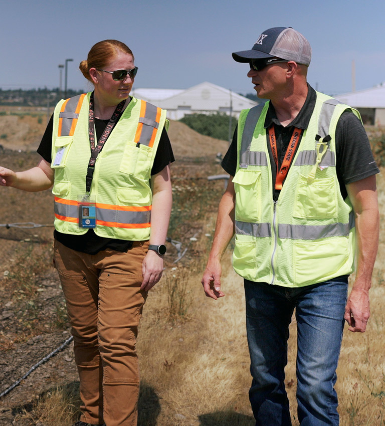 two employees walking in a stormwater management site