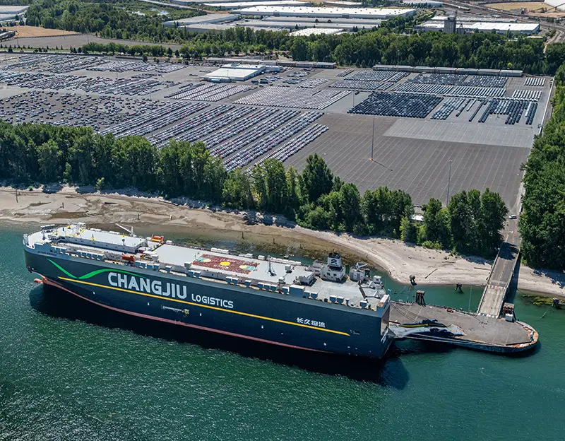 Aerial of Changjiu Logistics vessel unloading vehicles at Terminal 6