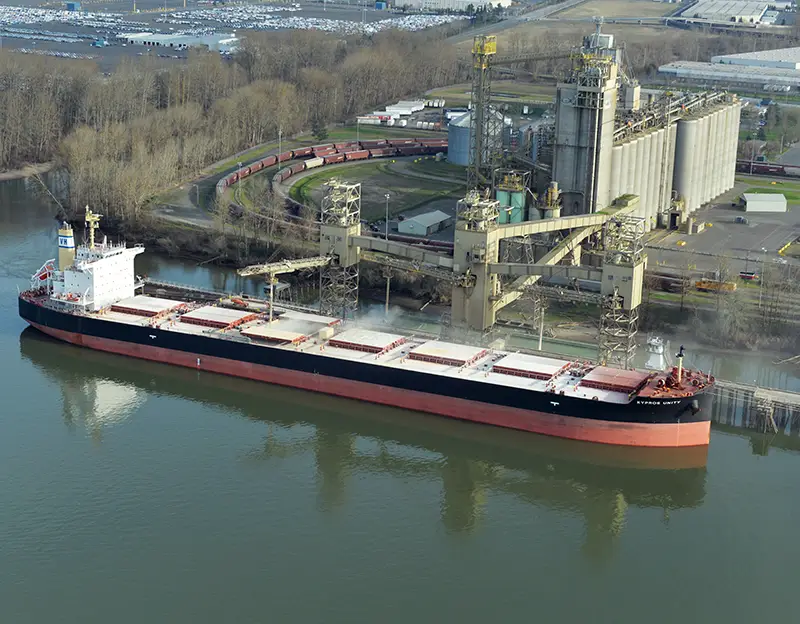 Aerial of Terminal 5 shows a vessel unloading fertilizer for railway transport