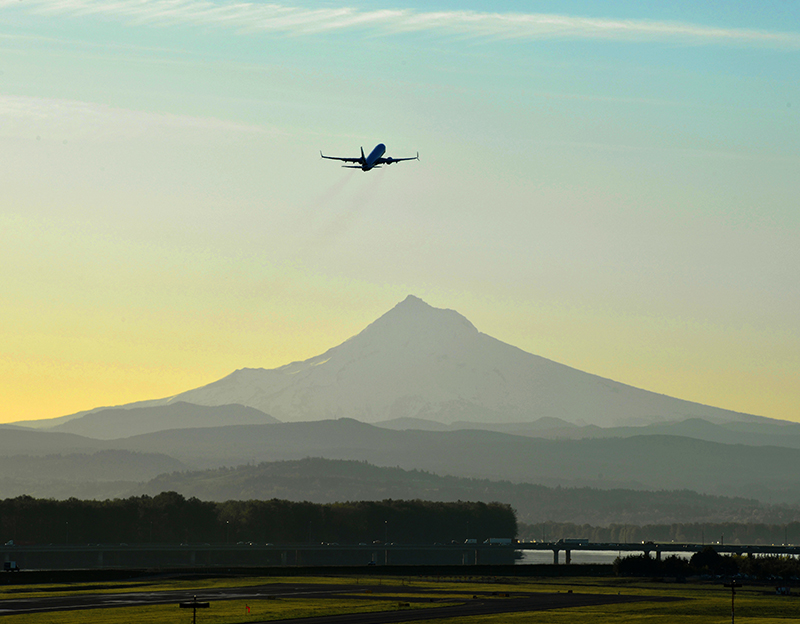 plane departing over the Columbia river