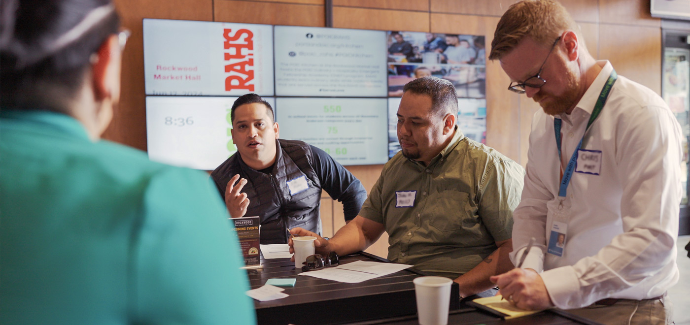 a man is engaged in discussion and gesturing while speaking