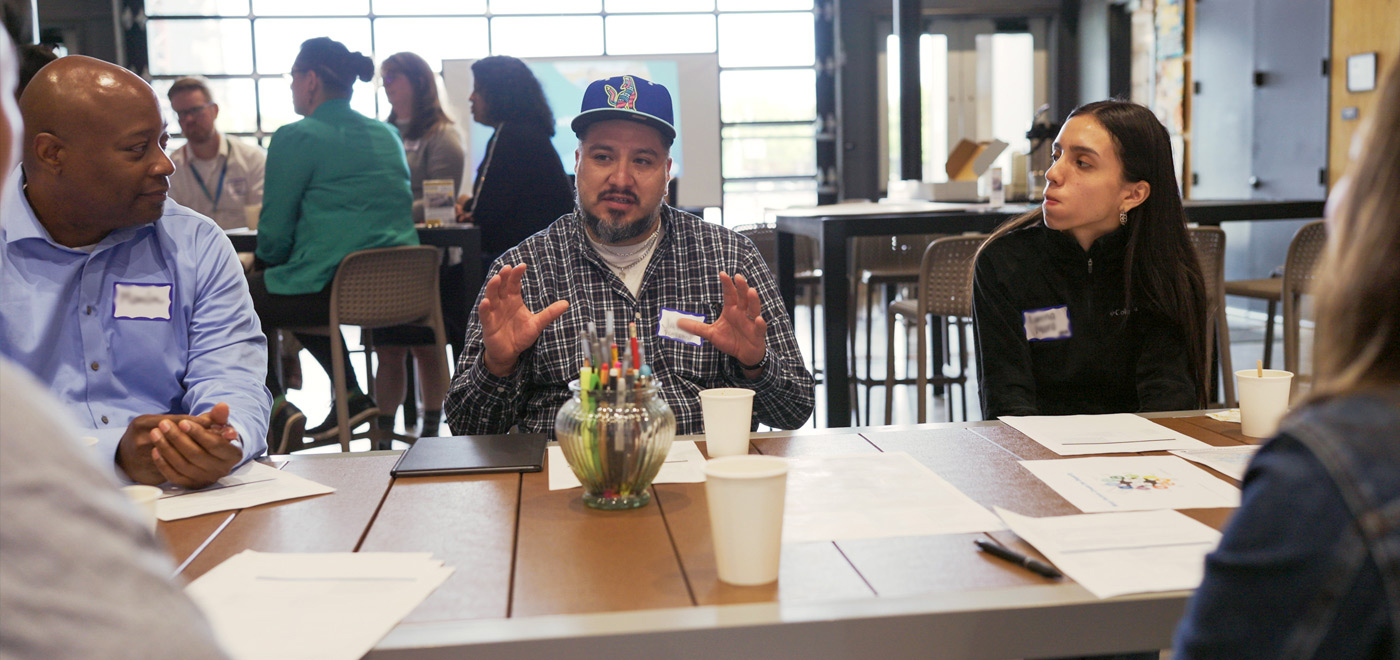 a man is gesturing for emphasis while discussing