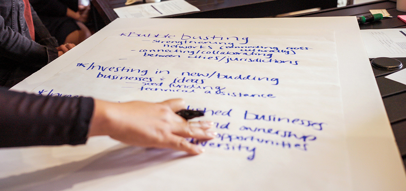 a woman's hand is writing the takeaways from a discussion