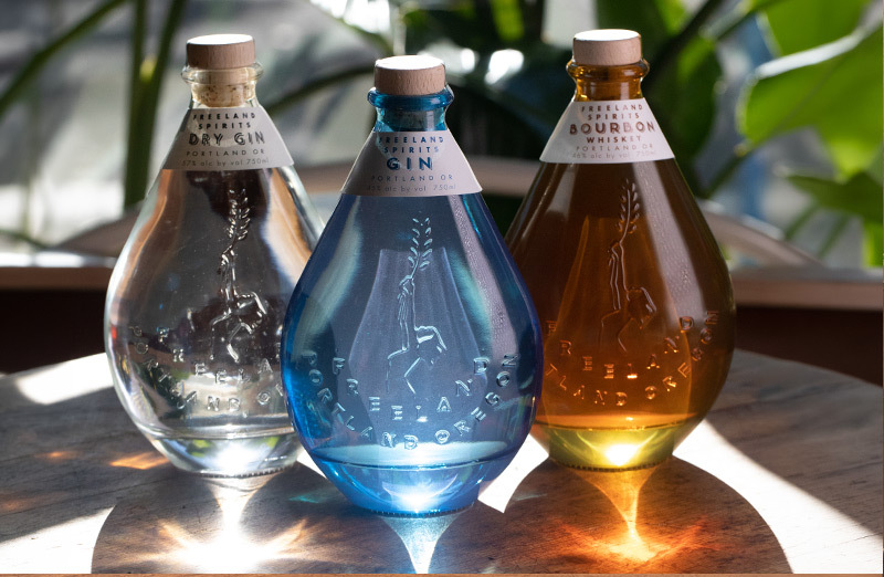 Freeland Spirits specialty gin in green and blue bottles