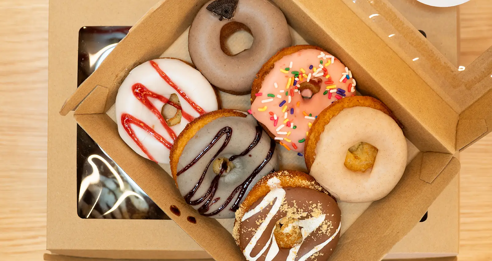 a tight shot of six colorful Mikiko Mochi Donuts in a to-go container from above