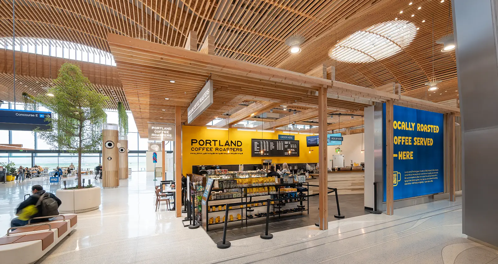 a wide shot of Portland Coffee Roasters bright yellow storefront